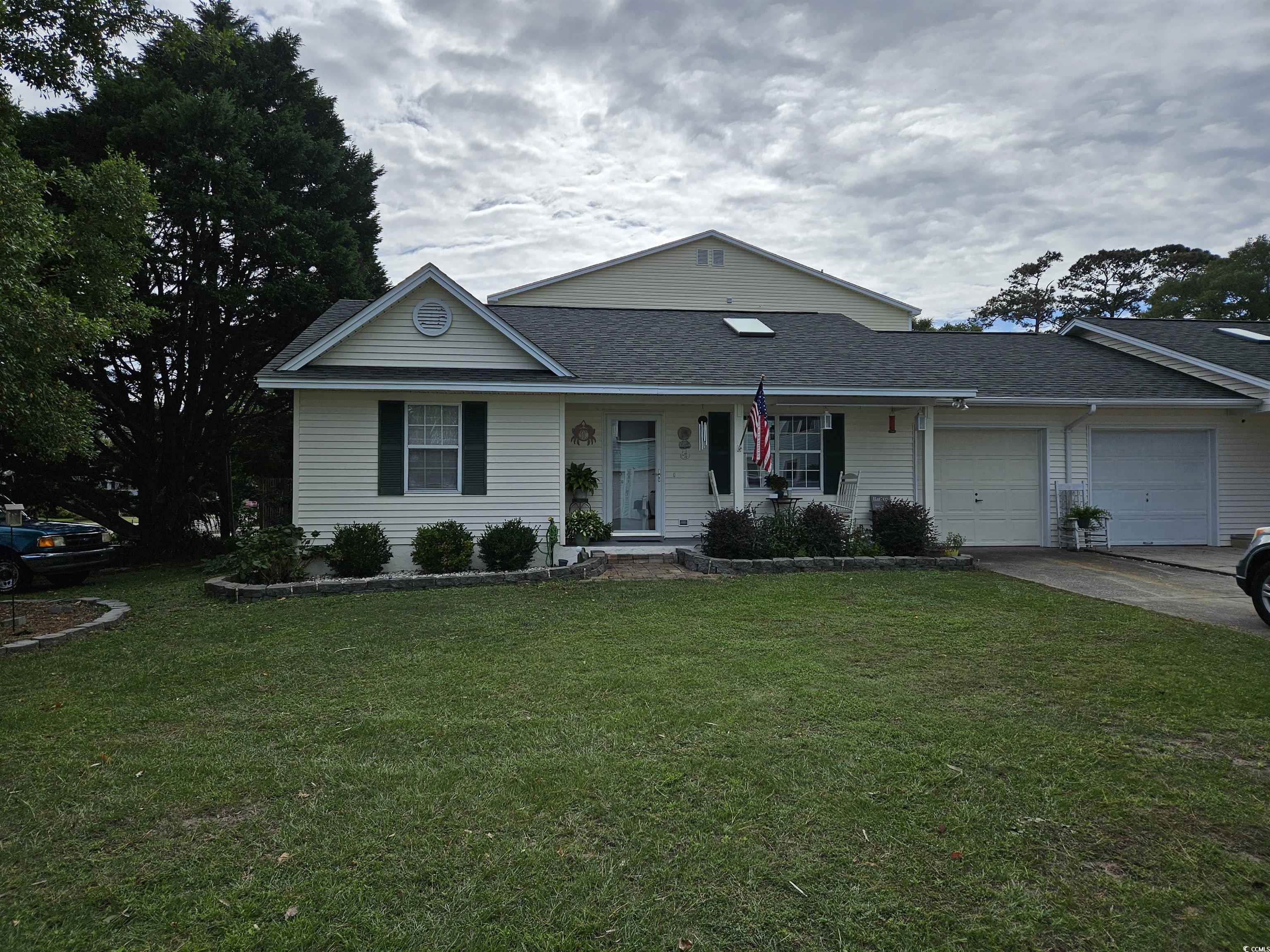 Ranch-style home with a front yard, a garage, and