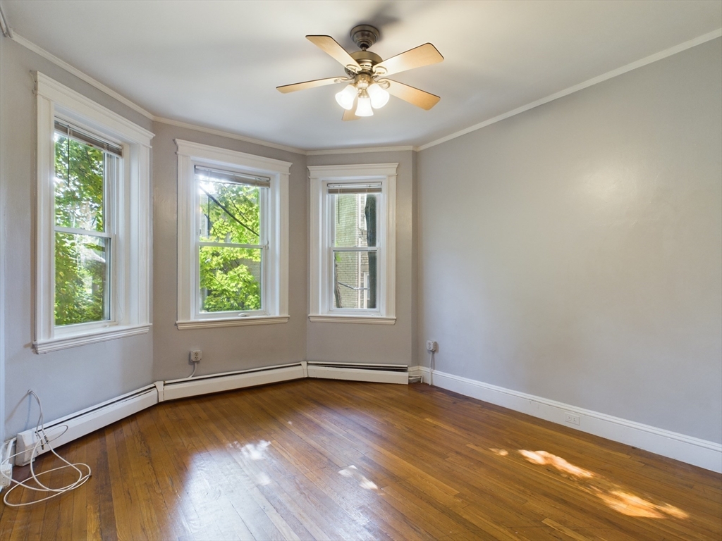 wooden floor in an empty room with a window