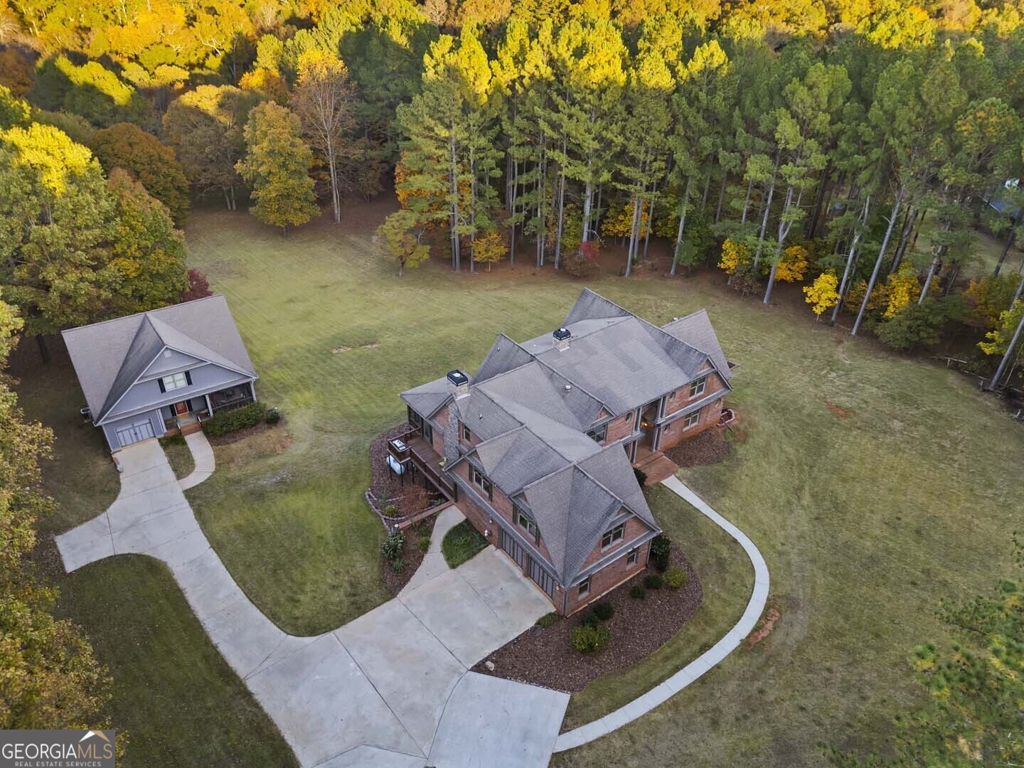 an aerial view of a house with garden space and street view