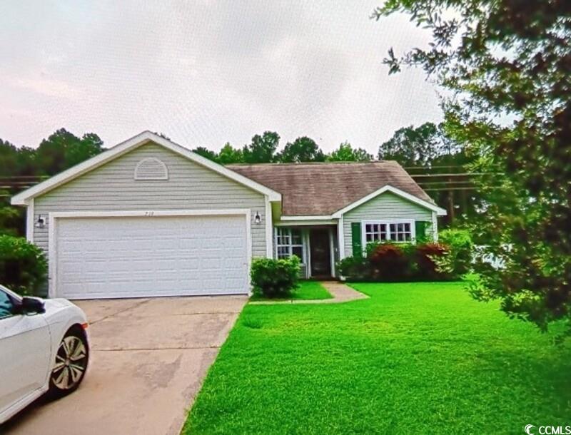 Single story home featuring a garage and a front l