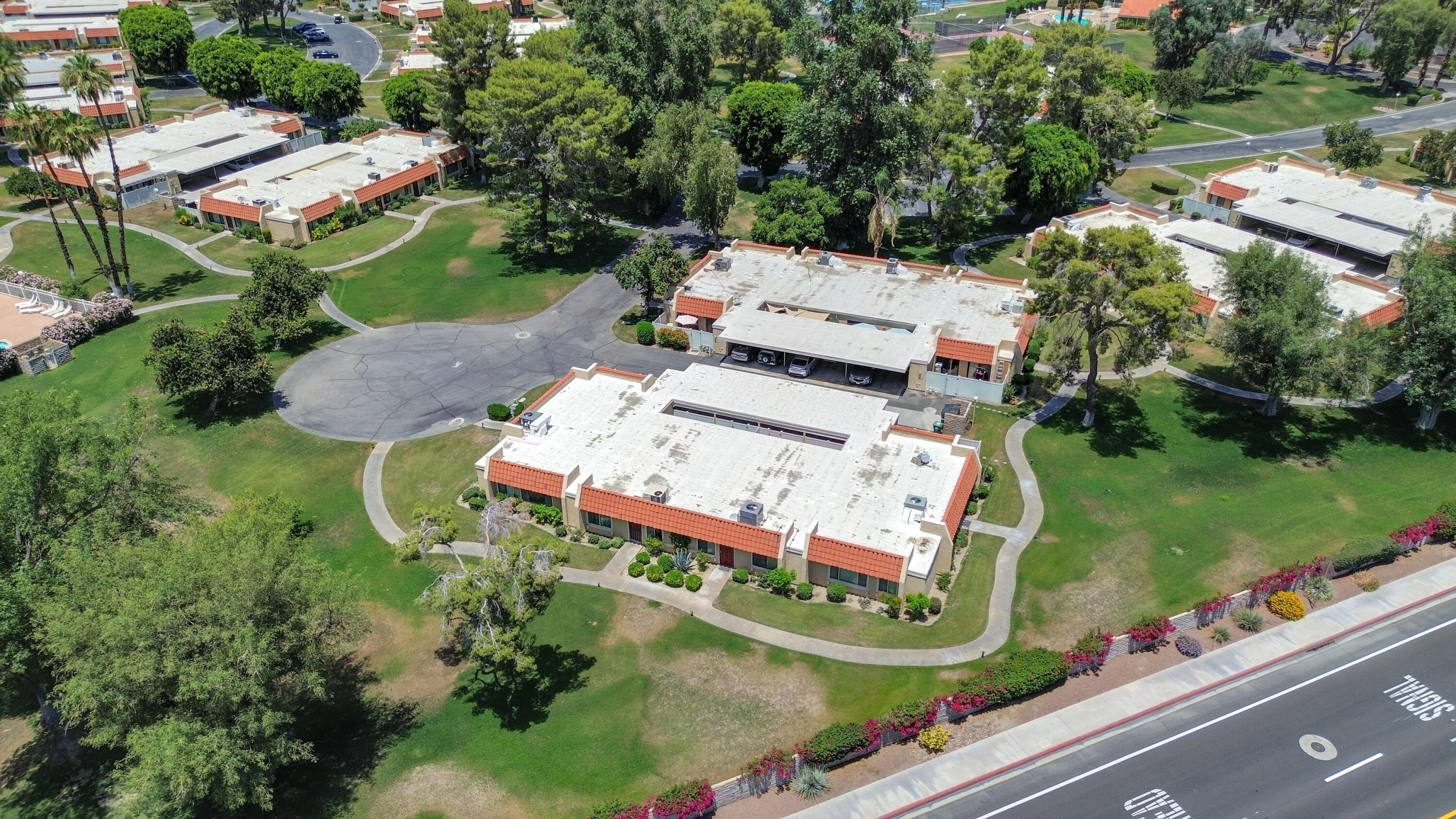 an aerial view of a house with a garden and lake view