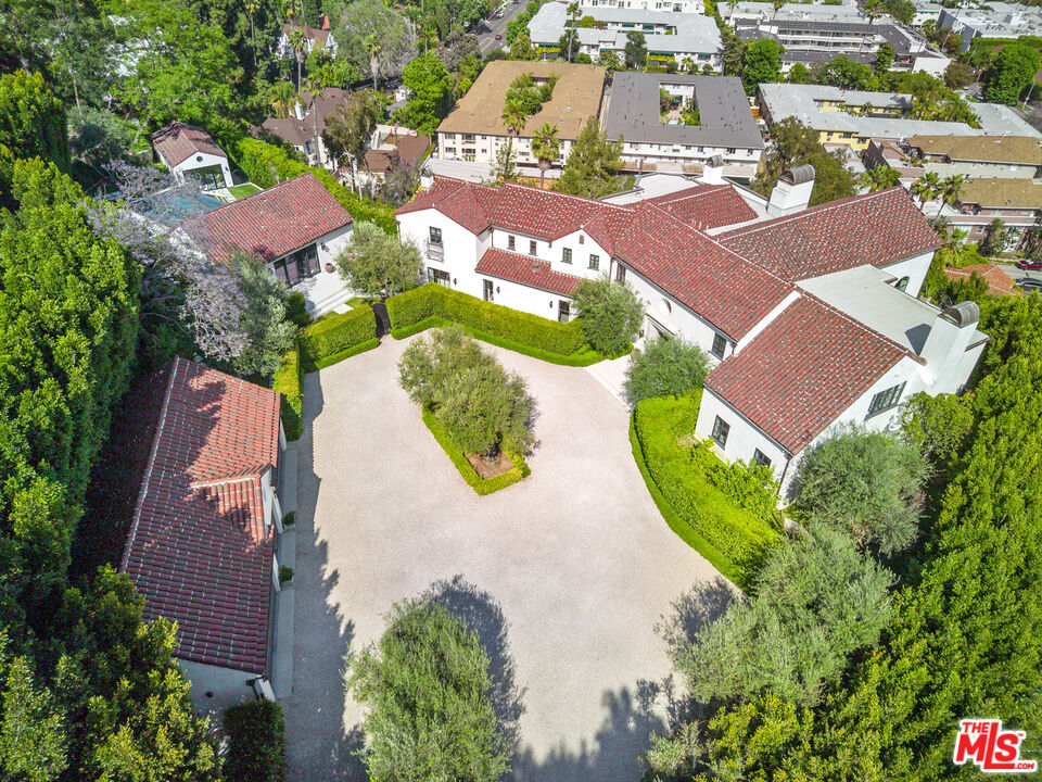 an aerial view of a house with a swimming pool