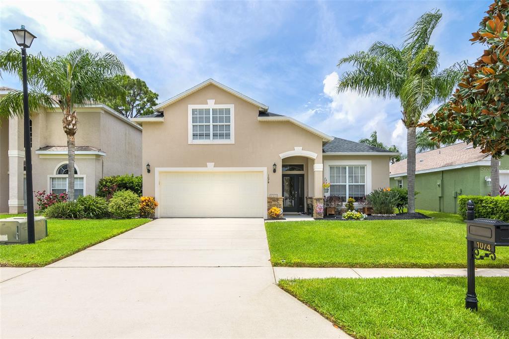 a front view of a house with a yard and garage