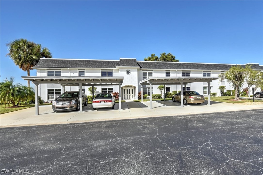 a view of a cars park in front of building