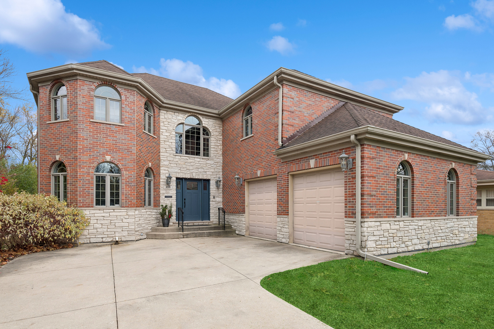 a front view of a house with a yard and garage