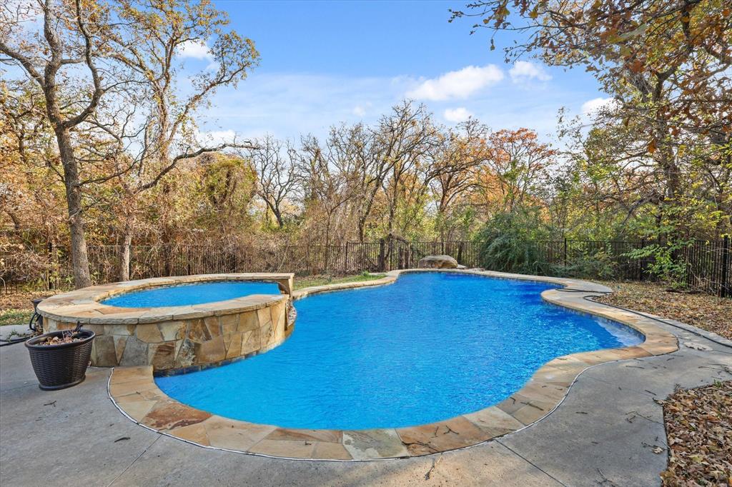 a view of a swimming pool with an outdoor space and seating area