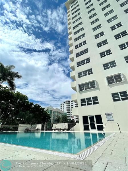 a view of building with river in front of it