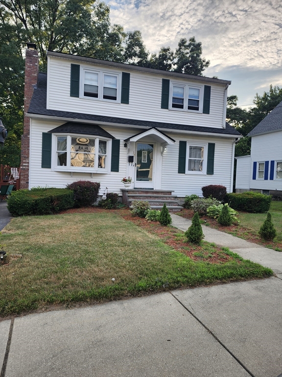 a front view of a house with a garden