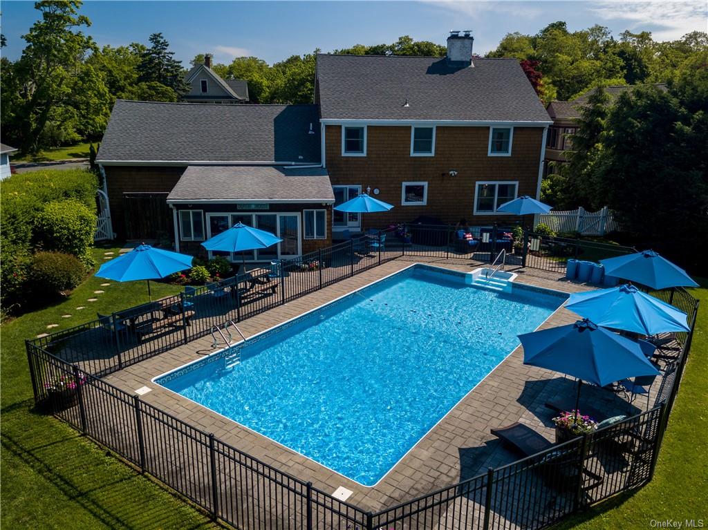 a view of a house with swimming pool and sitting area