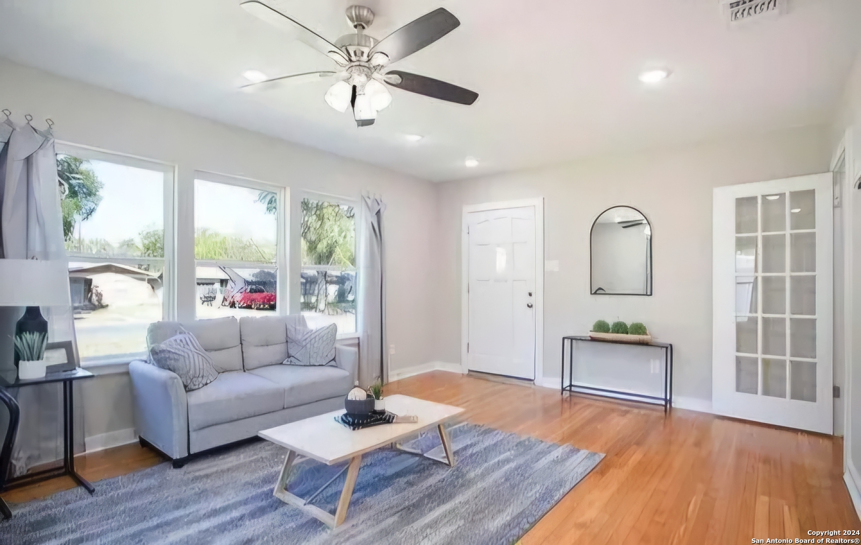 a living room with furniture and wooden floor