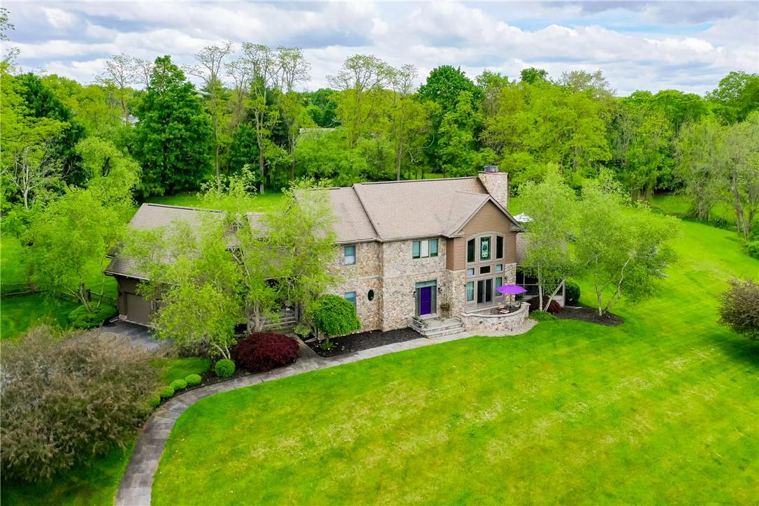 a view of a house with pool and garden