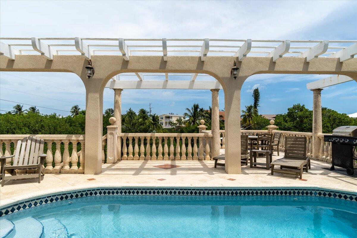 a balcony with table and chairs