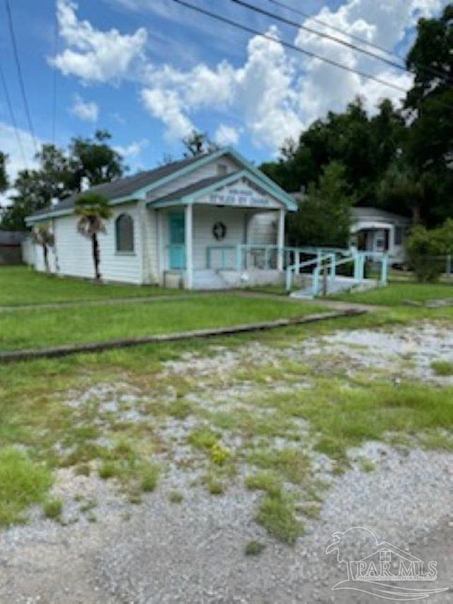 a front view of a house with a garden