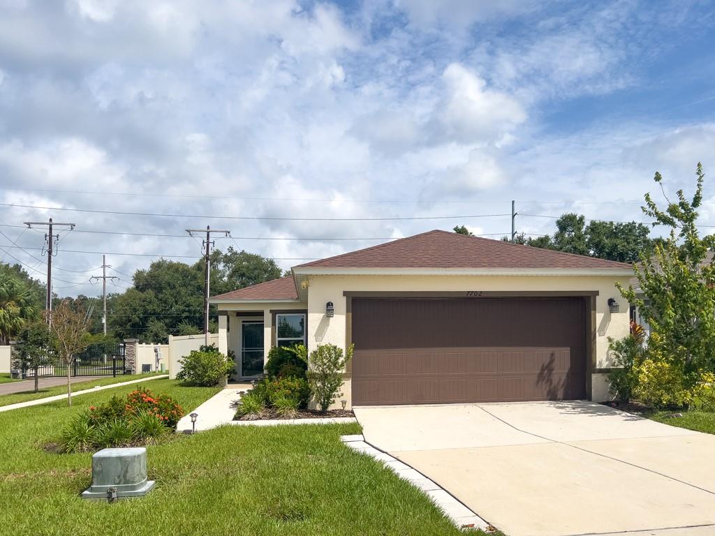 a front view of a house with a yard and garage