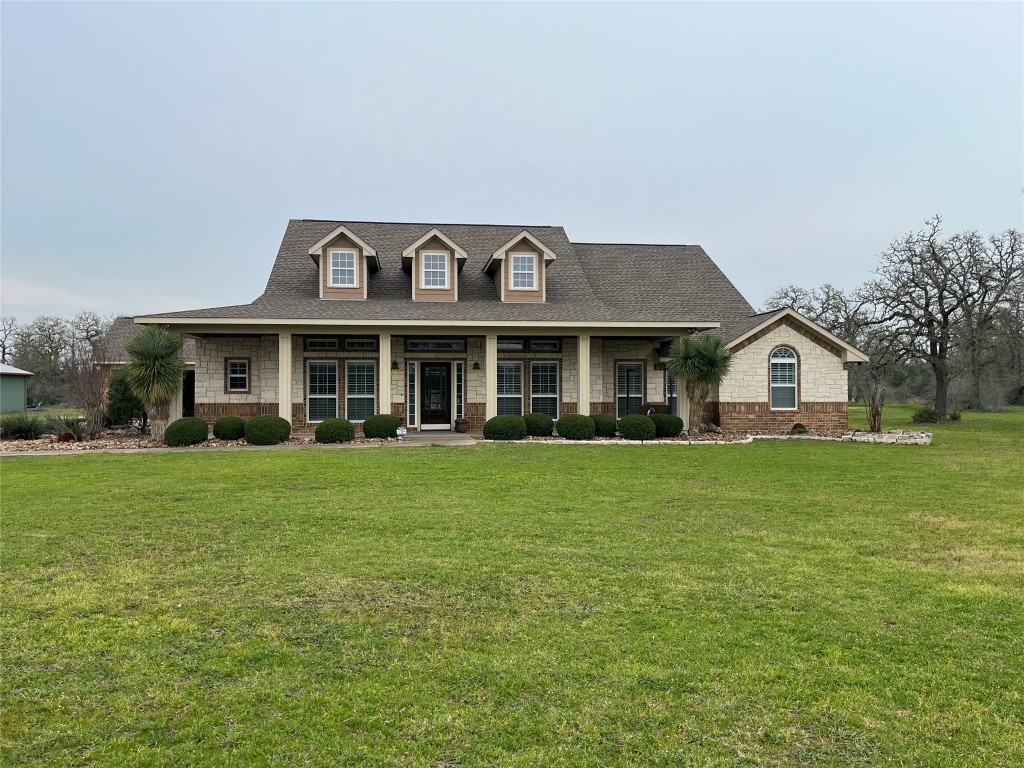 a front view of a house with a garden