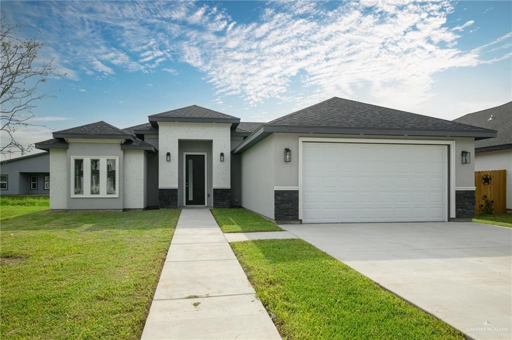 a front view of a house with yard