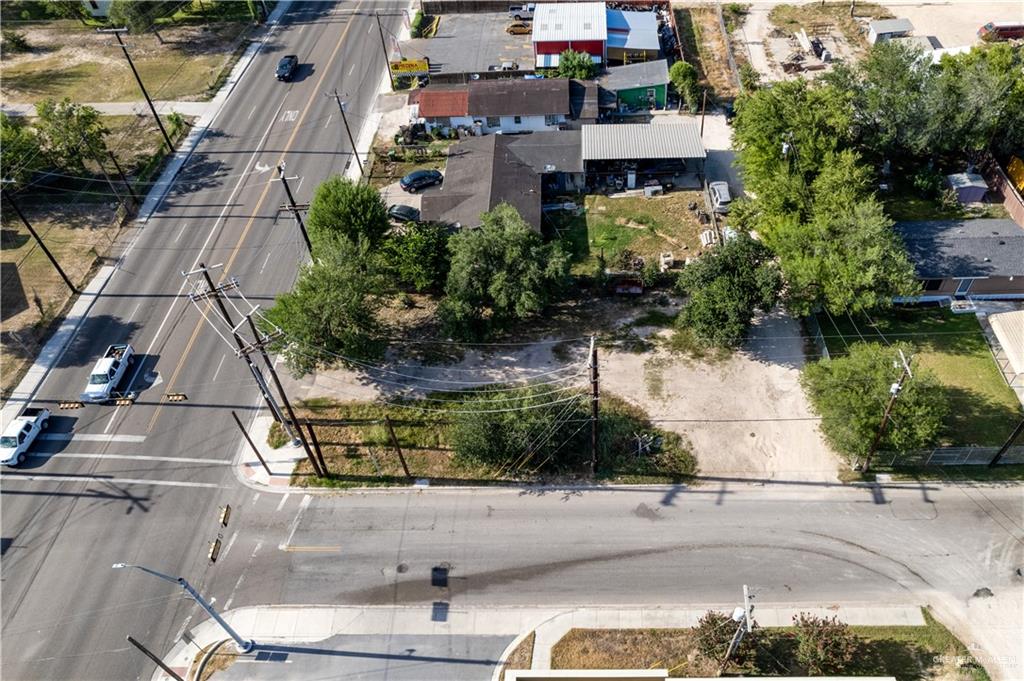 an aerial view of a house with a yard and potted plants