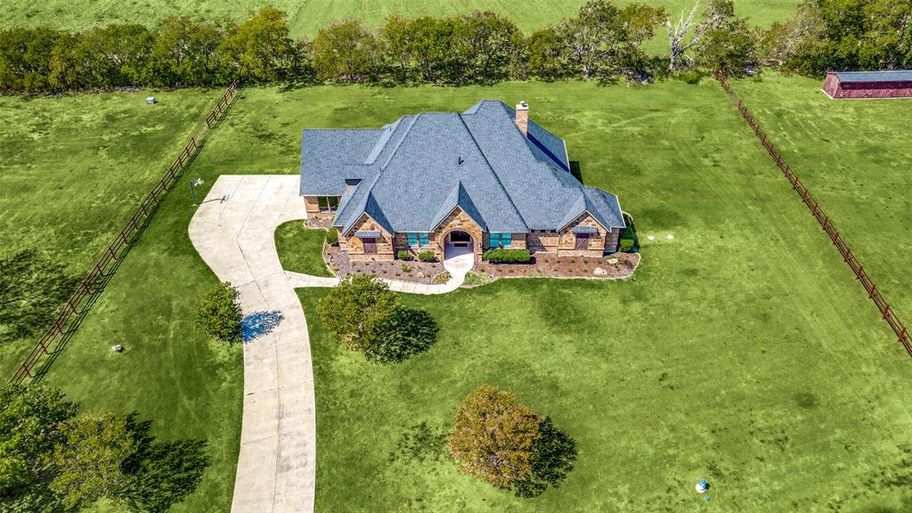 an aerial view of a house with yard swimming pool and outdoor seating