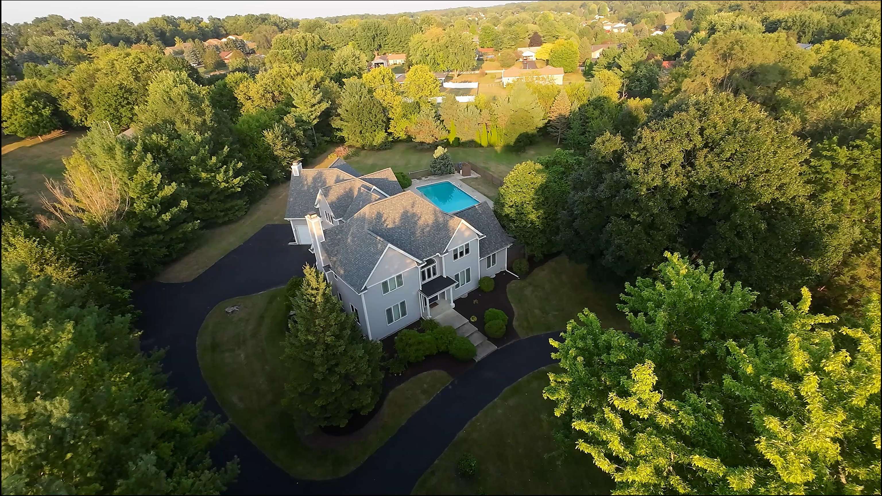 an aerial view of a house with a yard basket ball court and outdoor seating