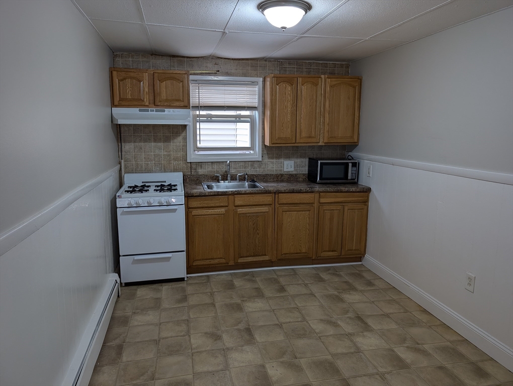 a kitchen with a stove a sink and a refrigerator