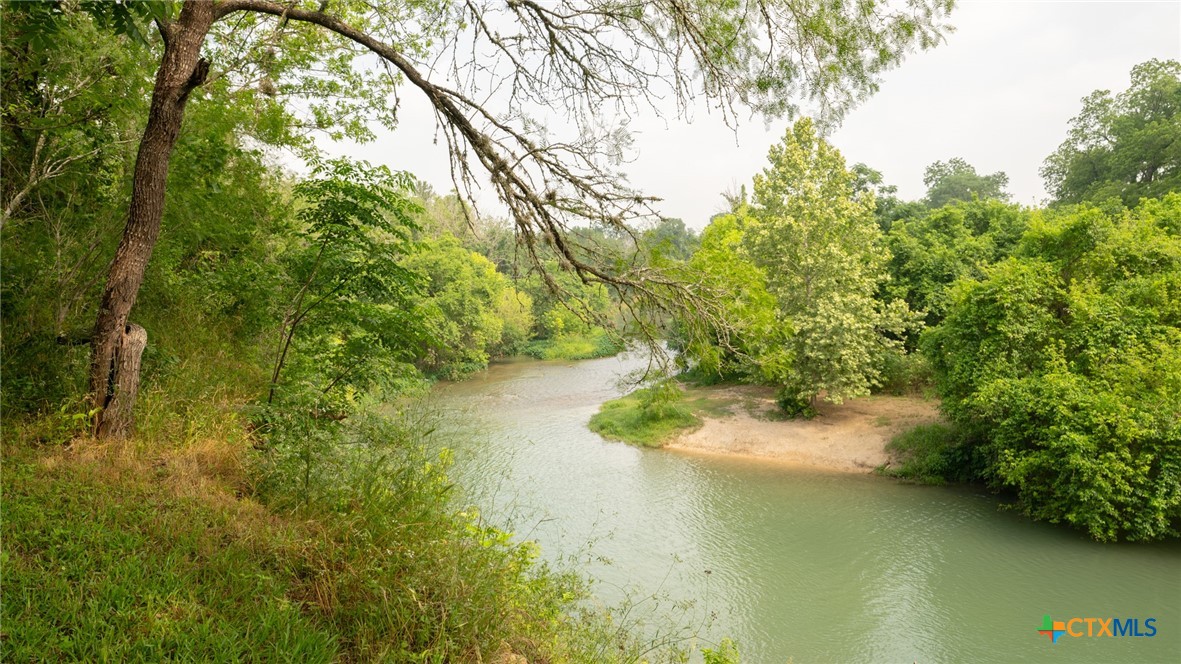 a view of a lake with a yard