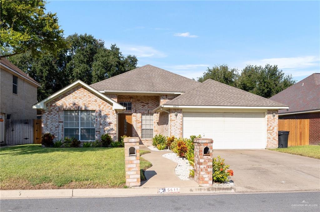 View of front of property with a garage and a front yard