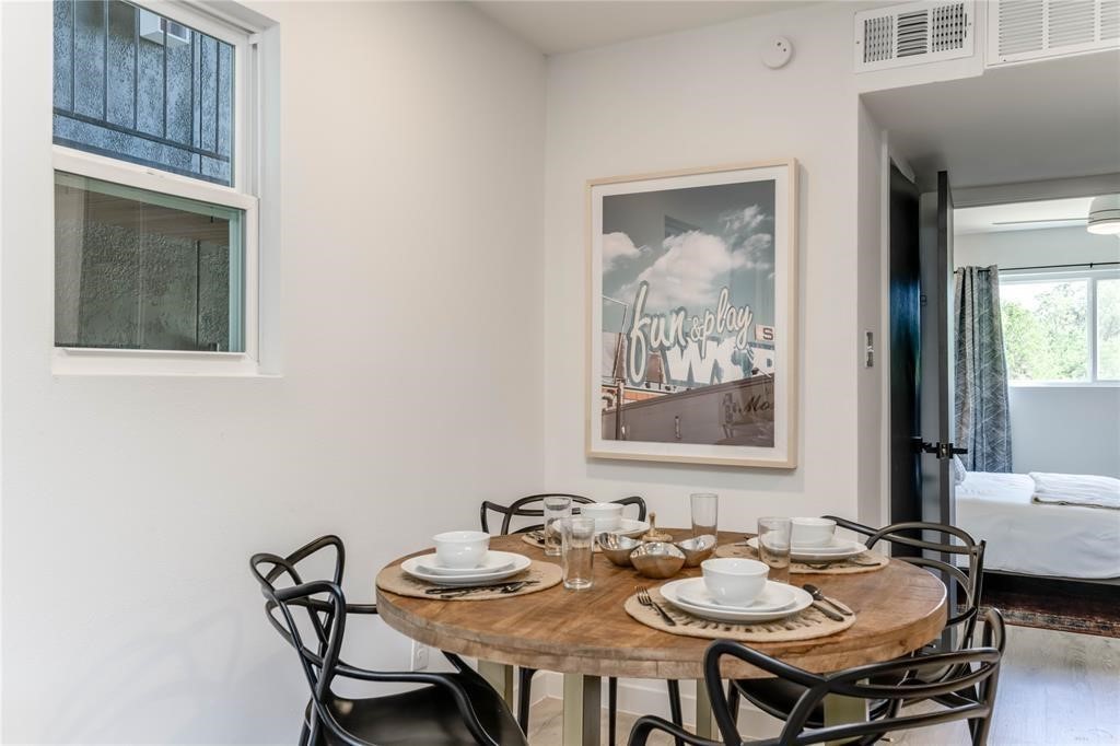 a dining room with furniture and window