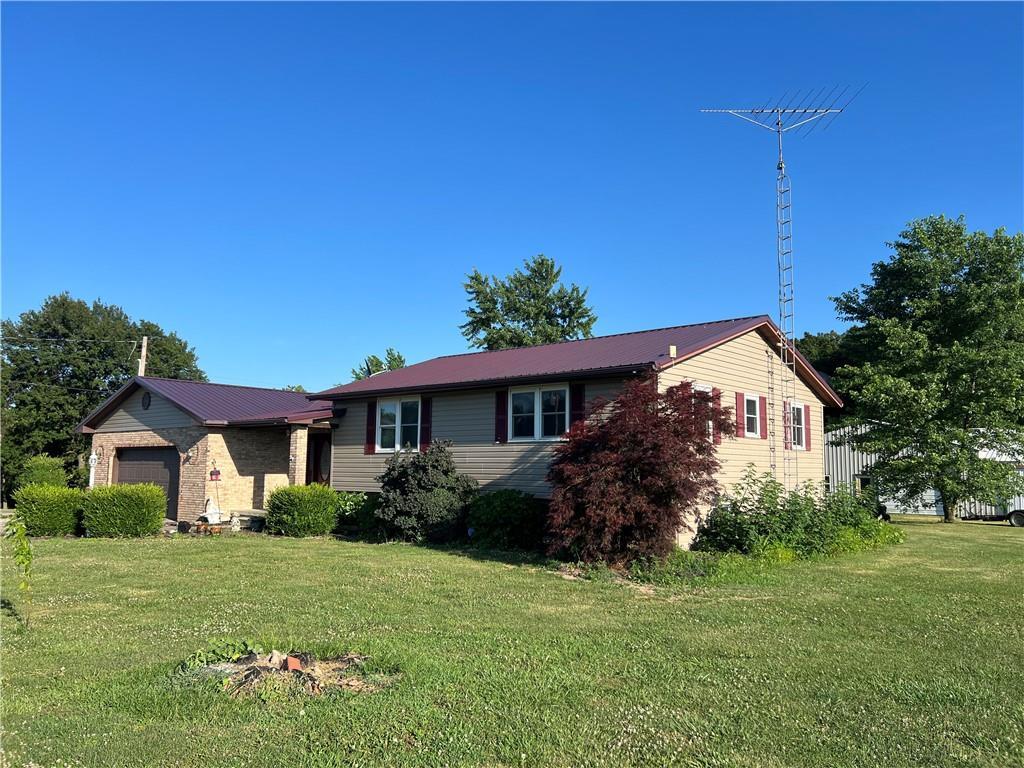 a front view of house with a garden