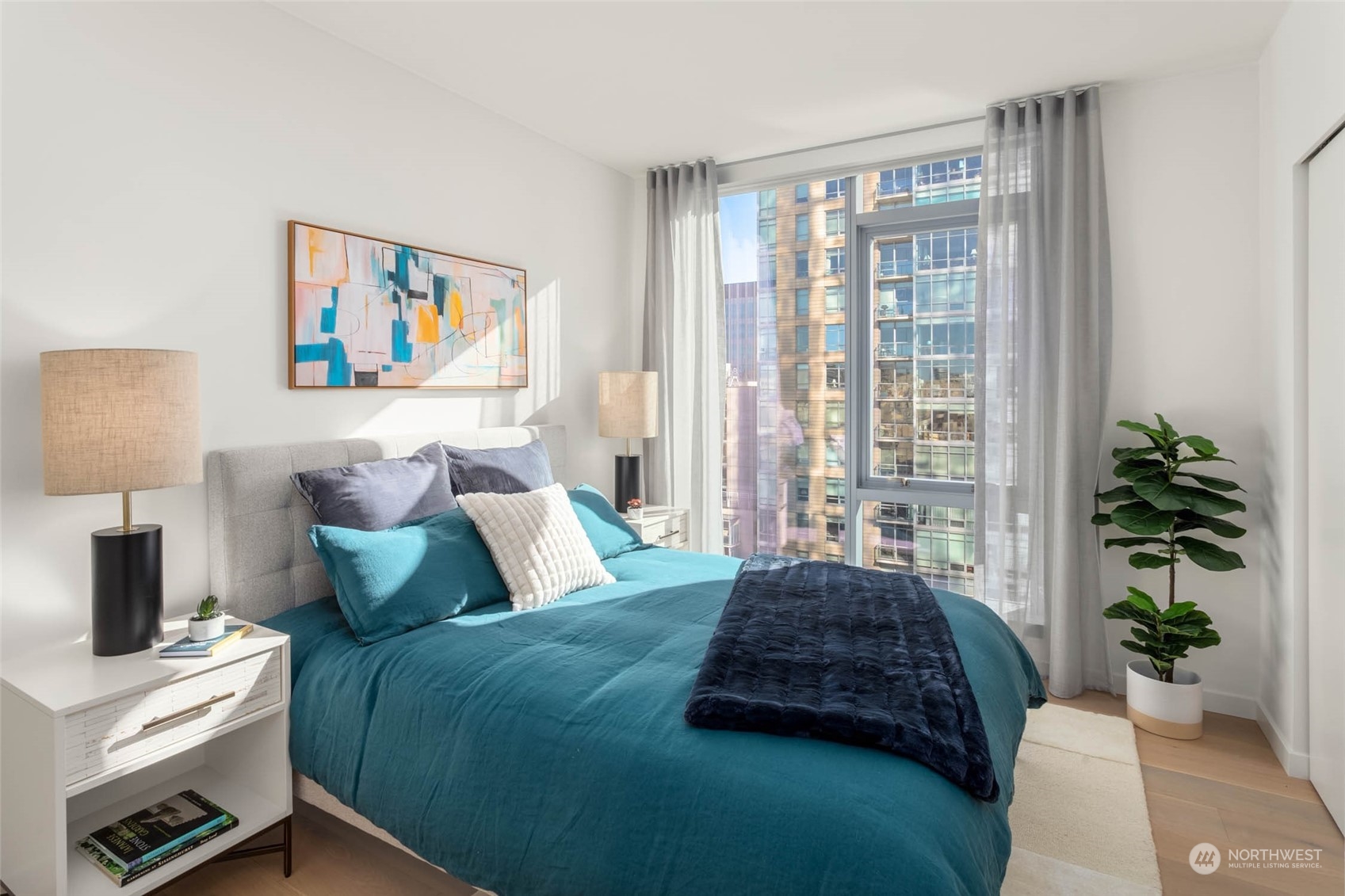 a bedroom with a bed and a potted plant