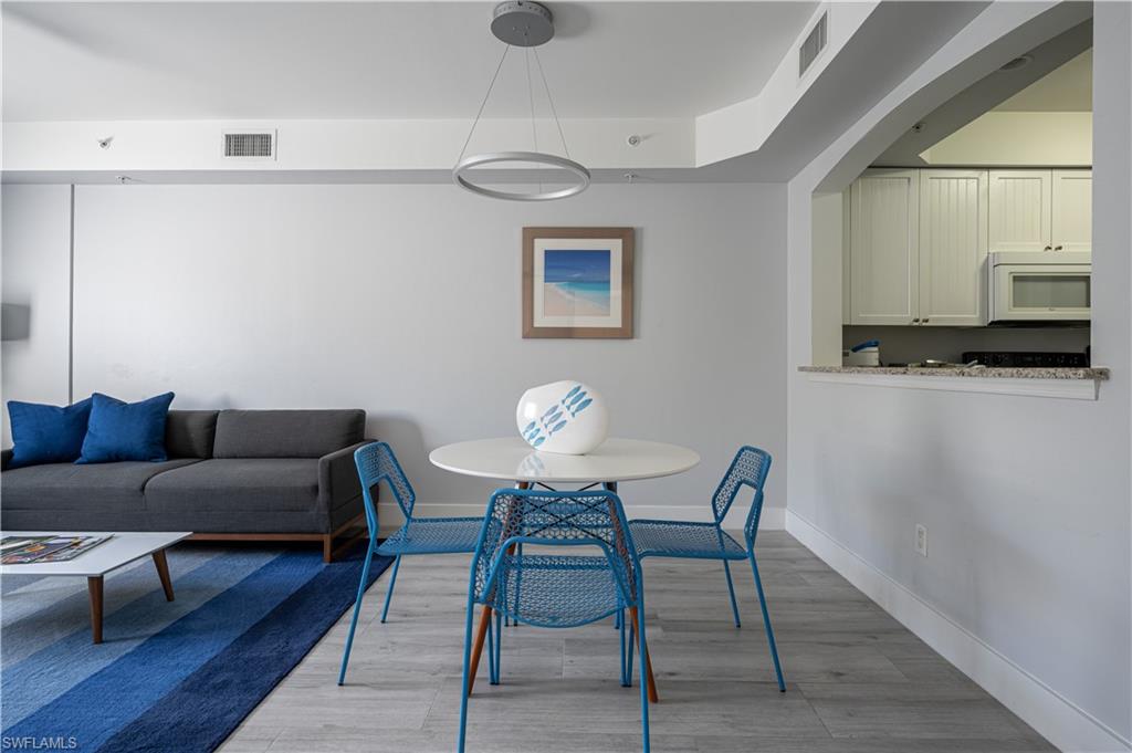 a view of a dining room with furniture and wooden floor