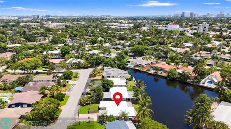 an aerial view of residential house with outdoor space and lake view