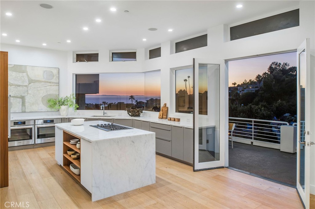 a kitchen with stainless steel appliances a stove and more cabinets