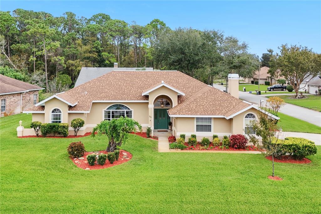 a view of an house with backyard space and garden