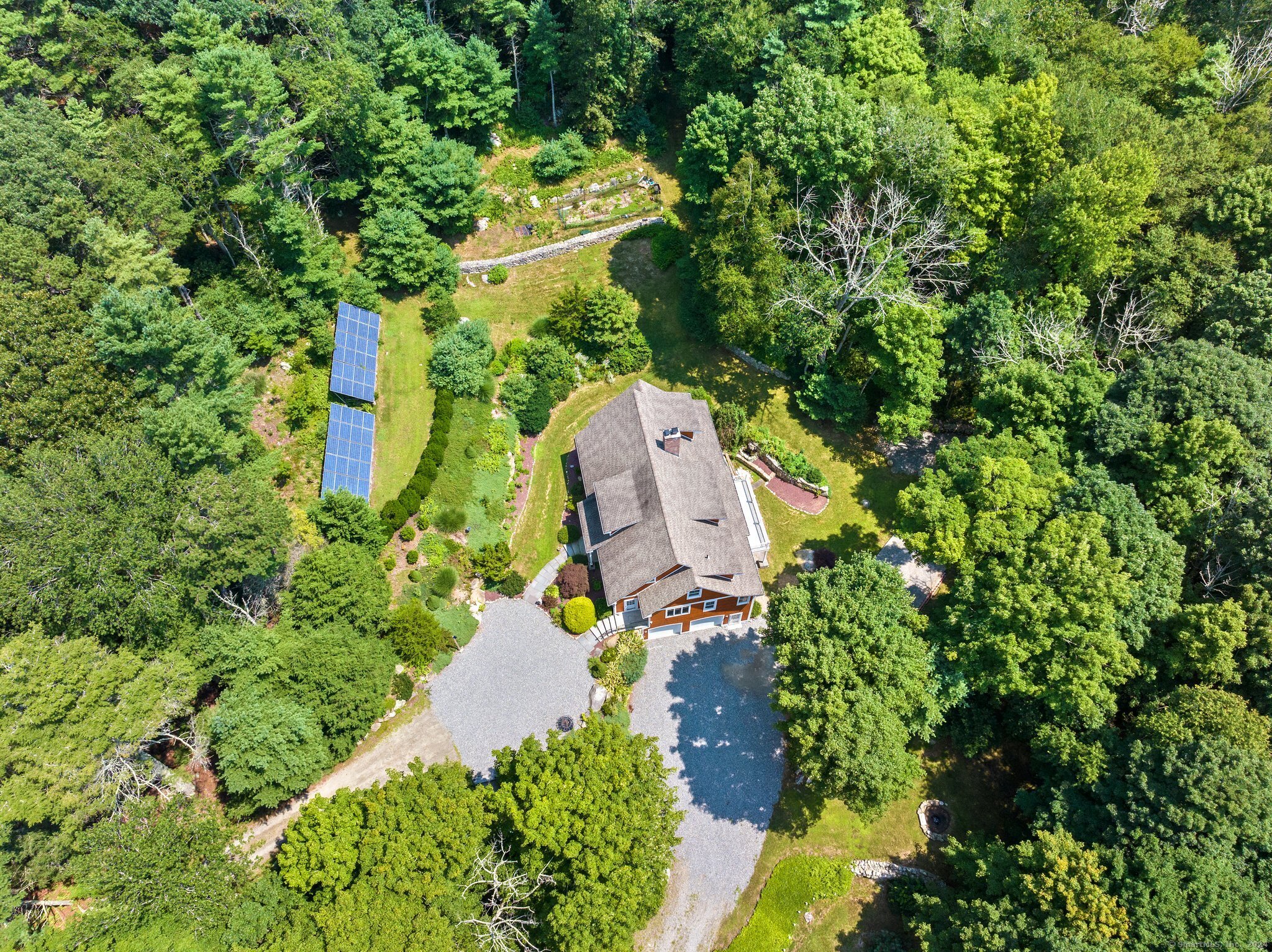 an aerial view of a house with a yard and swimming pool