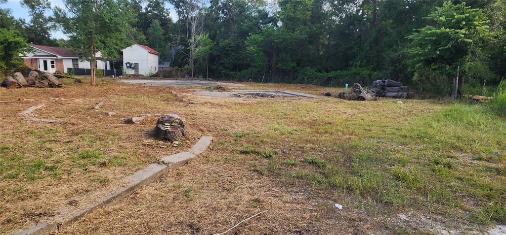 a view of yard with swimming pool and seating space