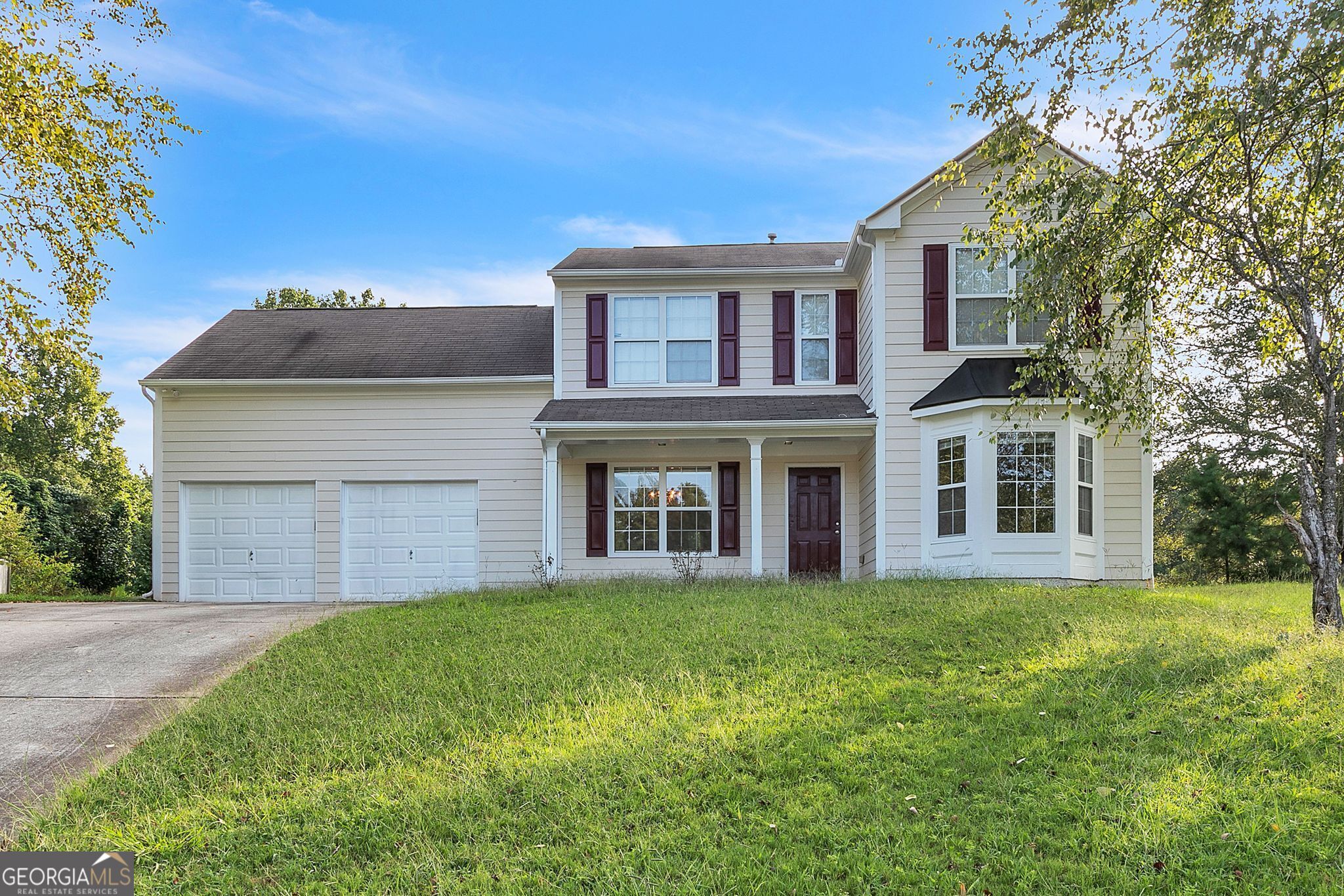 a front view of a house with a garden