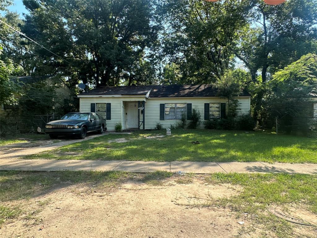 a front view of house with a garden