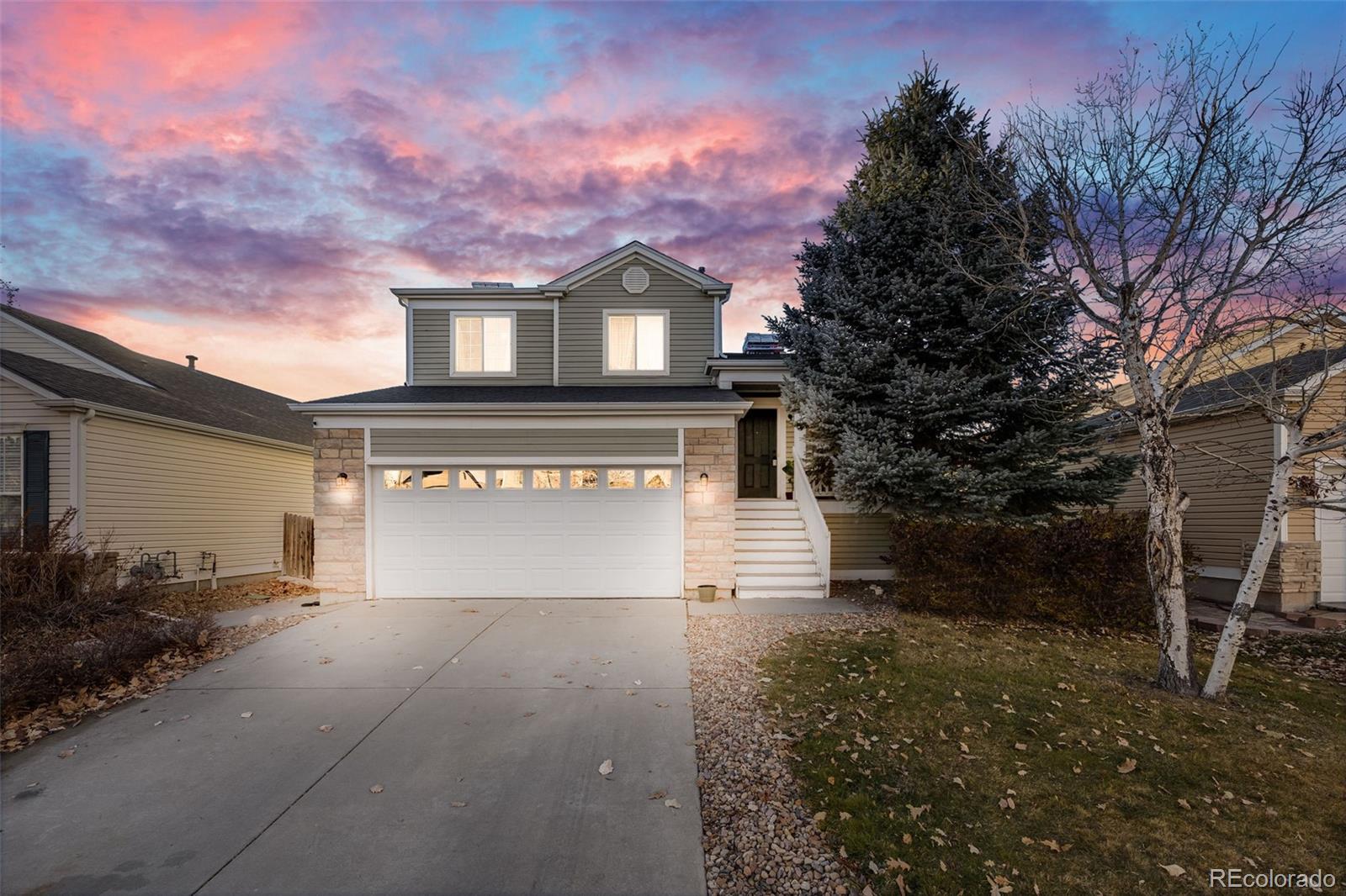 a front view of a house with a yard and garage