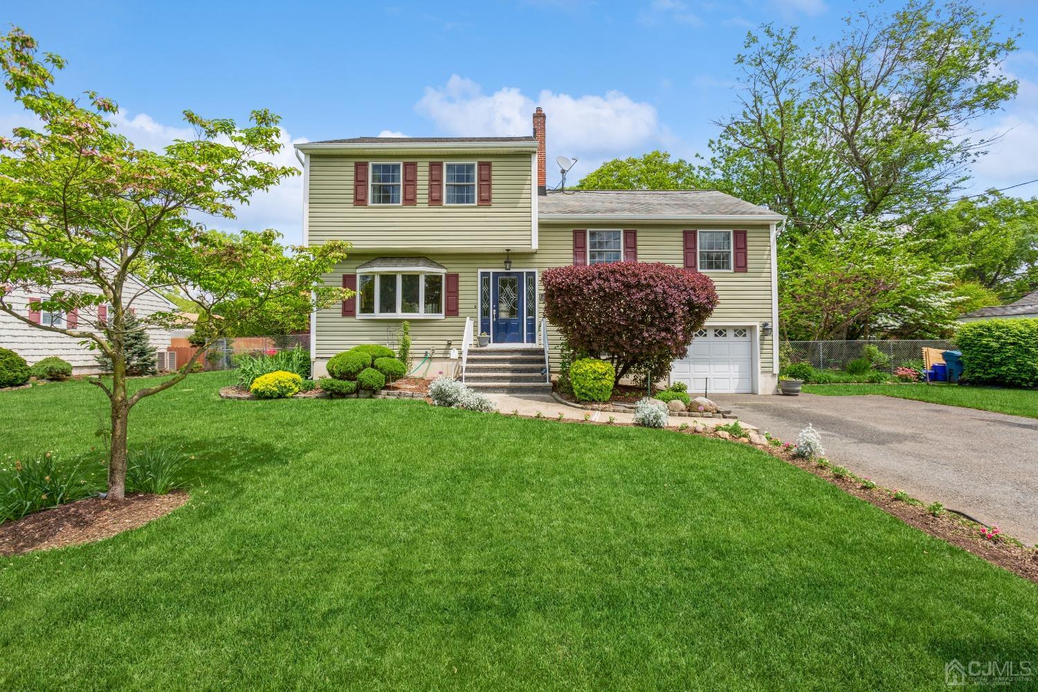 a front view of a house with a garden and porch