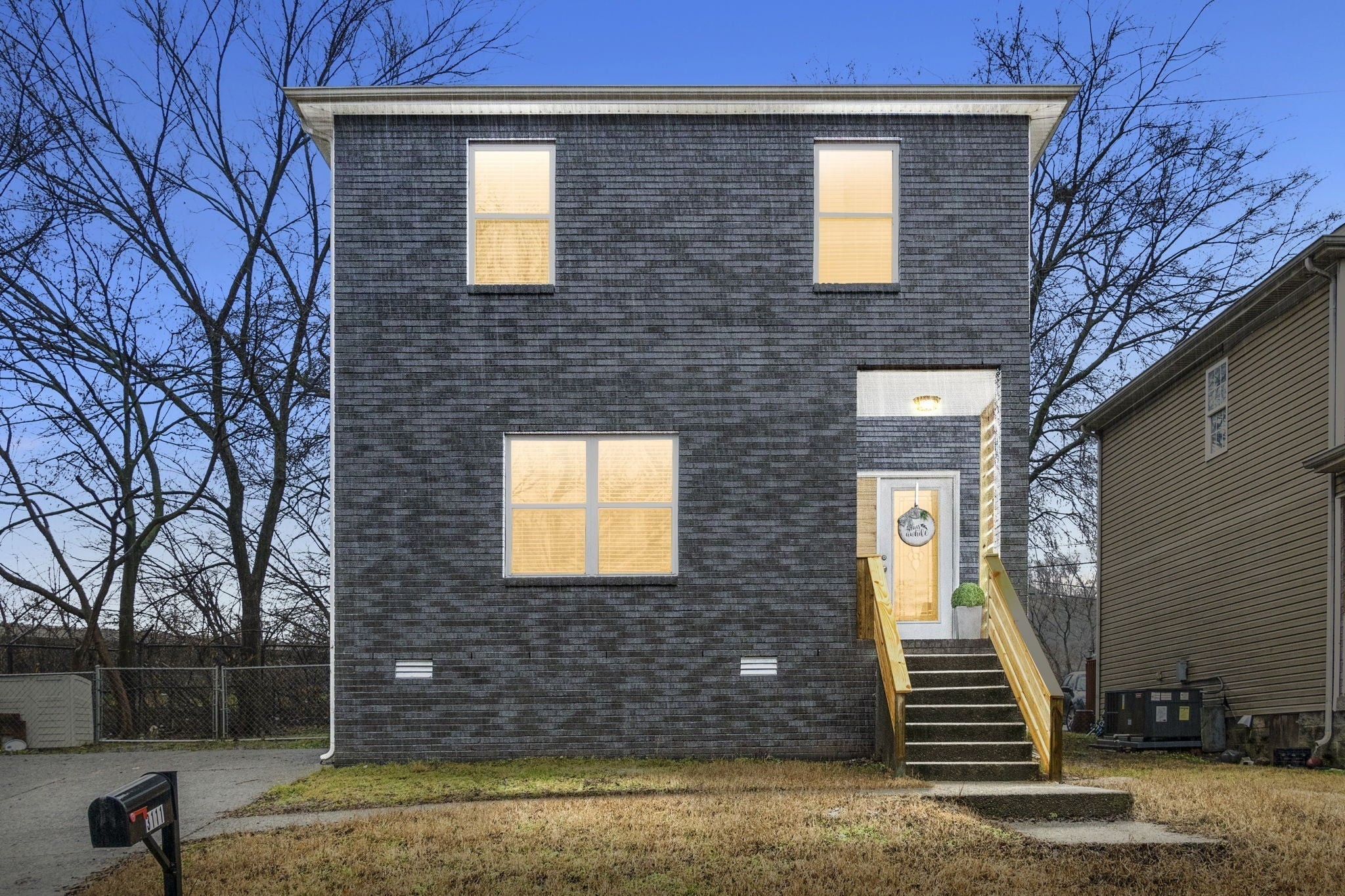 a view of a brick house with a yard