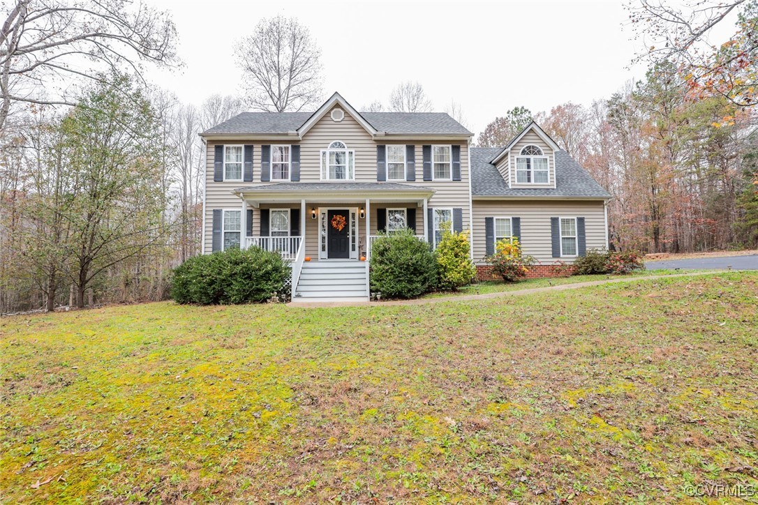 a front view of house with yard and trees around