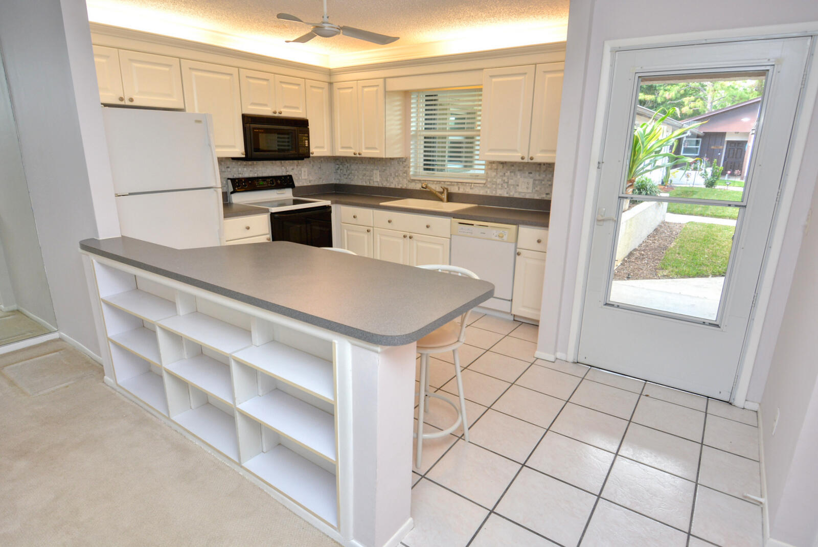 a kitchen with a sink a stove a microwave and cabinets