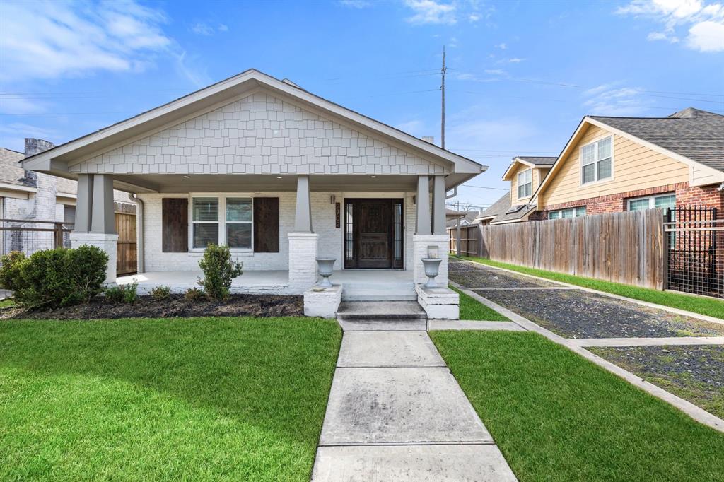 a front view of a house with a yard and outdoor seating