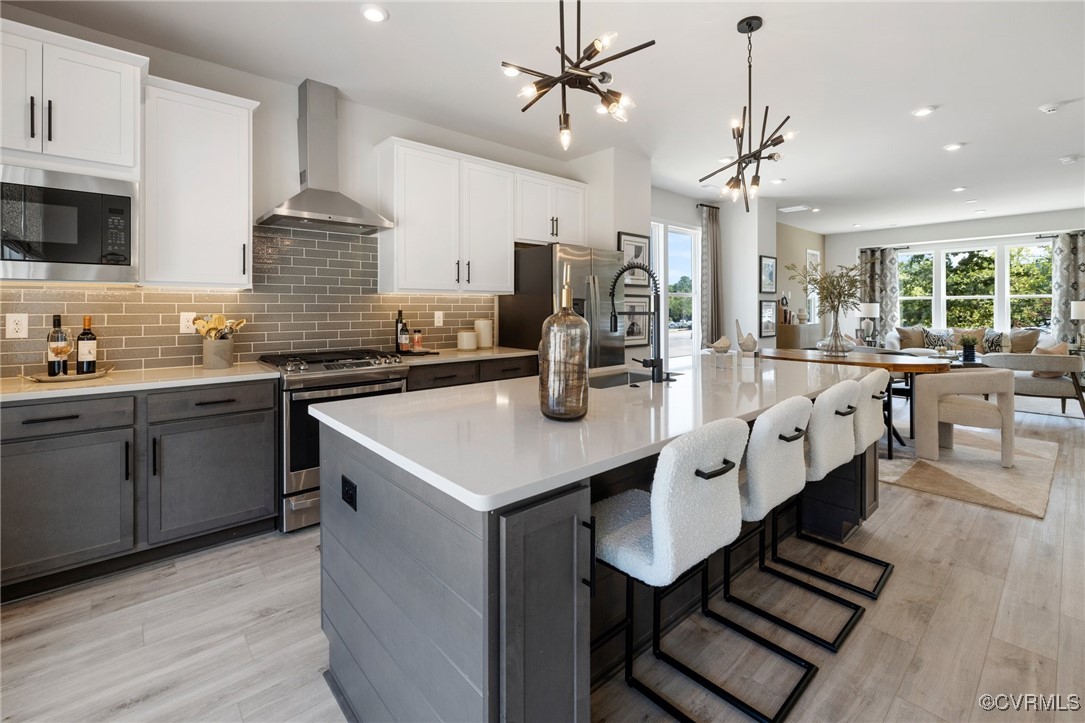 a large kitchen with a table and chairs