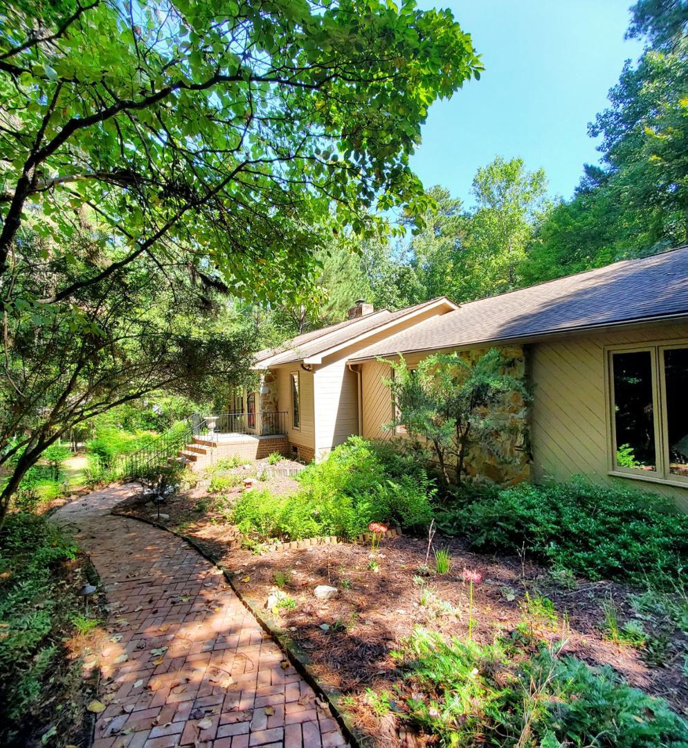 a backyard of a house with plants and trees