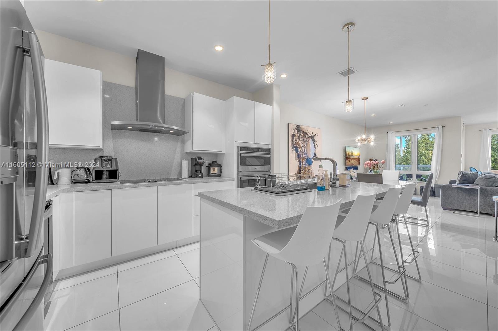 a kitchen with stainless steel appliances kitchen island granite countertop a sink and cabinets