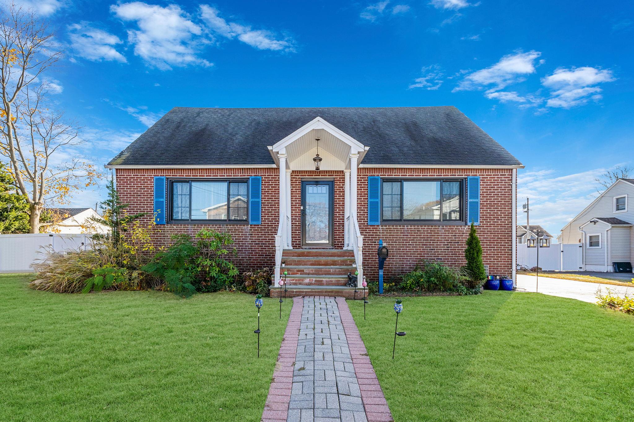 a front view of a house with garden