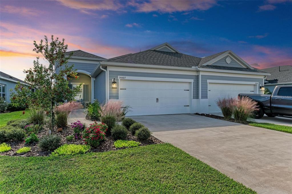 a front view of a house with a yard and garage