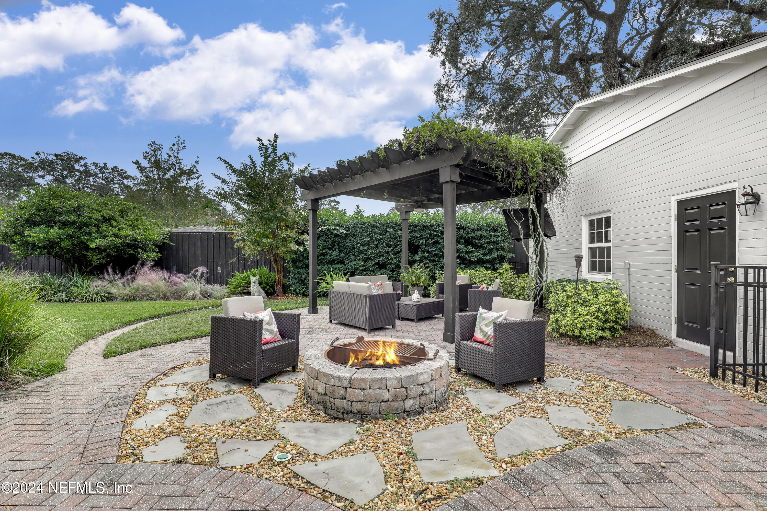 a view of a patio with couches chairs and a yard