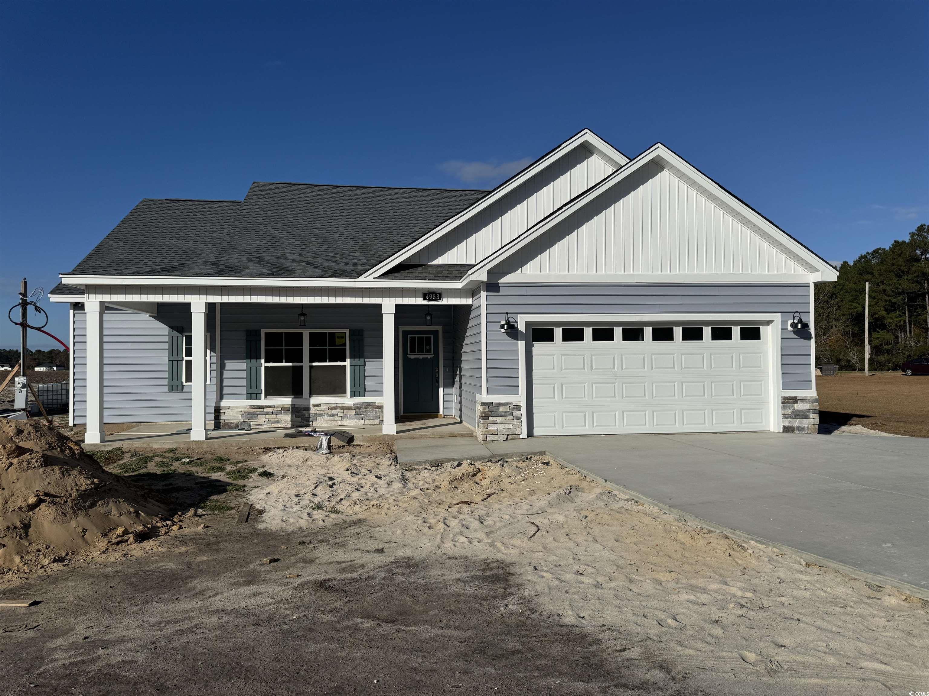 Craftsman house with a porch and a garage